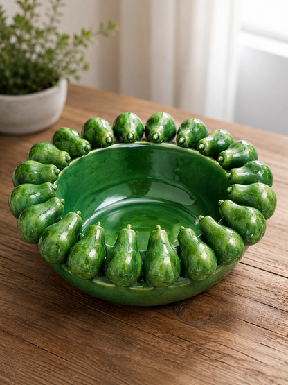 Green ceramic bowl with gourd-like design on a wooden surface