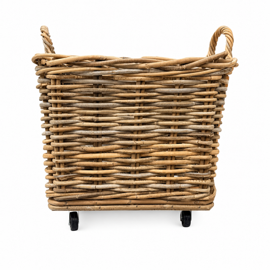 Wicker basket with handles on wheels against a white background